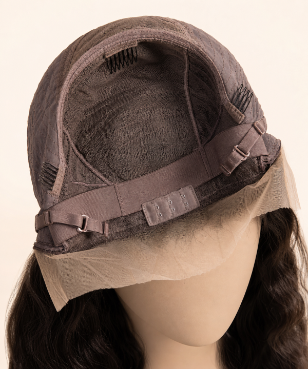 Interior view of a glueless wig cap showing adjustable straps, elastic band, combs, and 3D dome shape